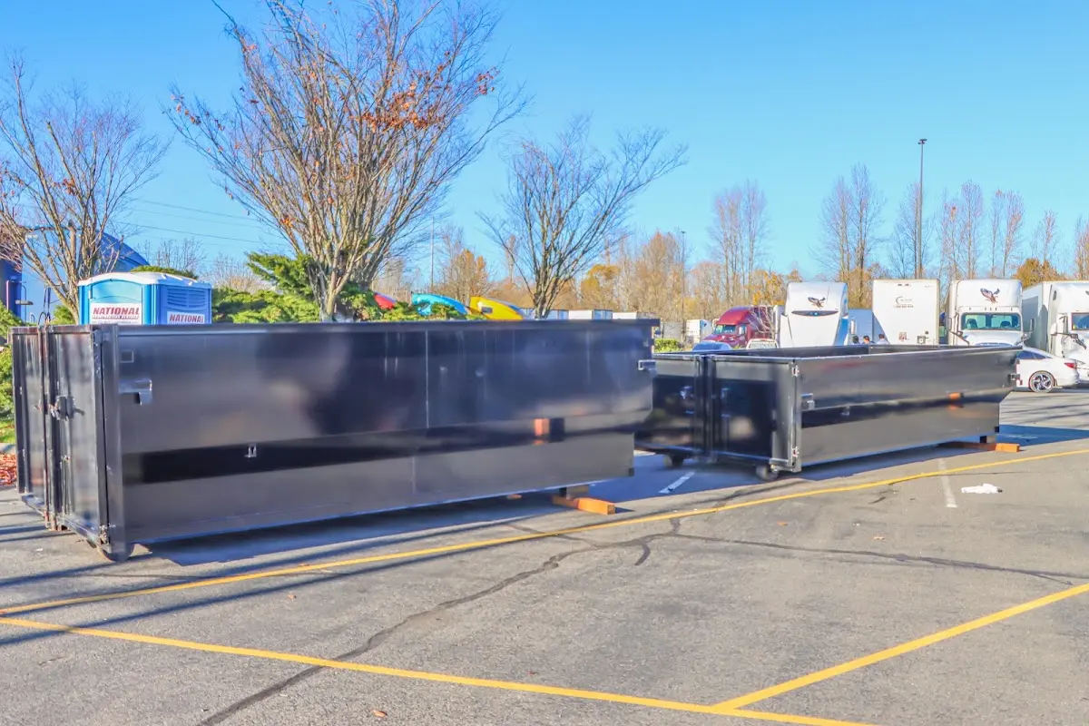 Professional dumpster rental service with roll-off container on residential driveway in Sheldon